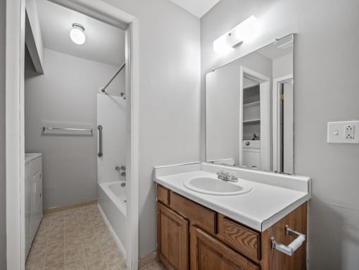 an empty bathroom with a sink and a mirror