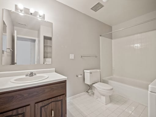 a bathroom with a sink toilet and a mirror