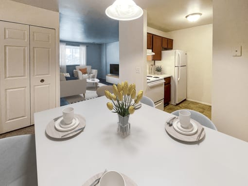 a dining room table with a vase of flowers    and a kitchen
