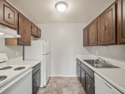 a kitchen with white appliances and wooden cabinets