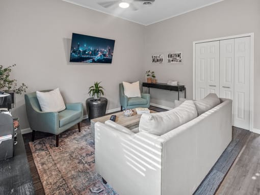 a living room with a couch and two chairs