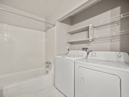 a white laundry room with a washer and dryer