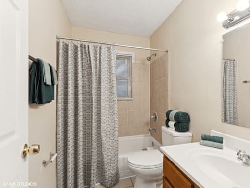 bathroom with a shower tub, toilet, and sink
