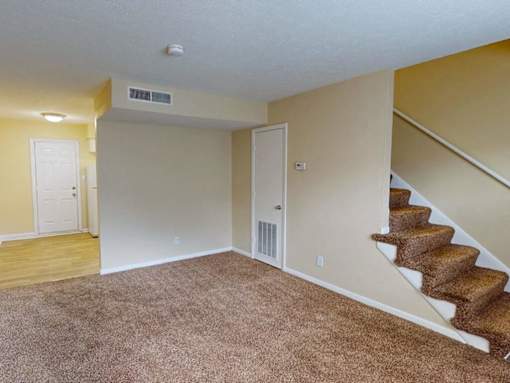 Living room with staircase to upstairs