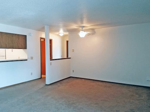 A room with a ceiling fan and a window.