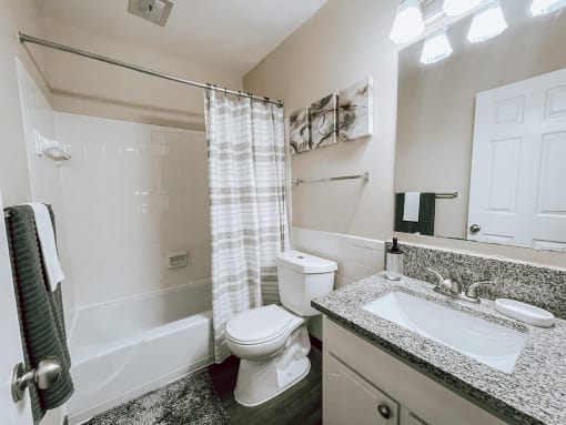 a bathroom with a sink toilet and a shower