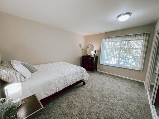 a bedroom with a bed and a window