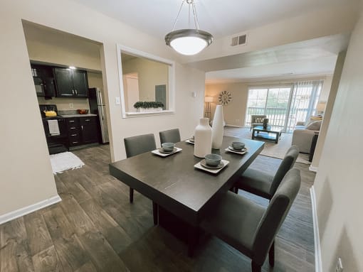 a dining room and living room with a table and chairs