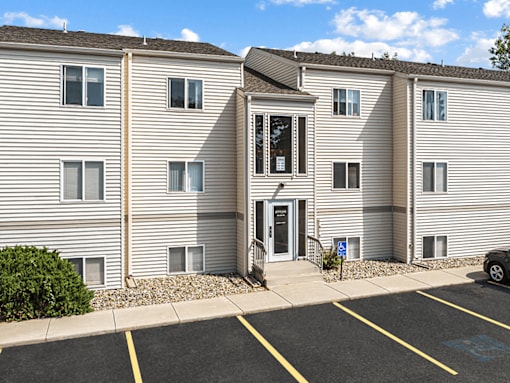 A building with a parking lot in front of it.