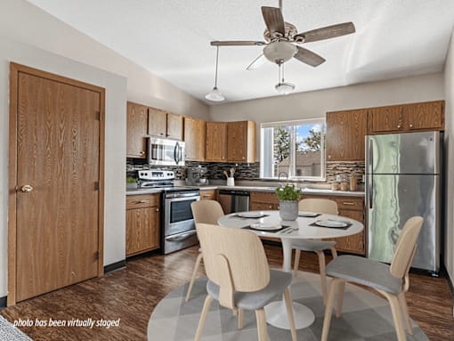 A kitchen with a table and chairs in the middle of the room.