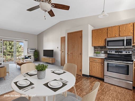 A modern kitchen with a dining table set for four.