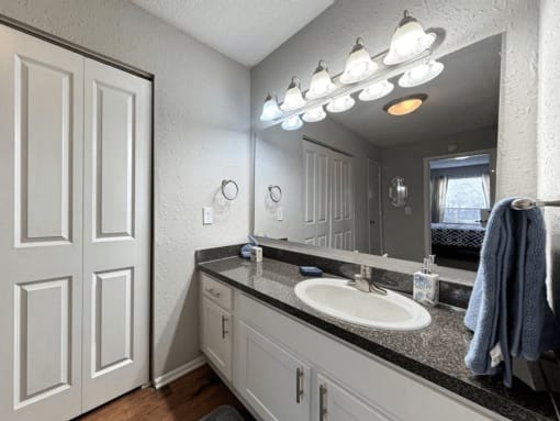 an empty bathroom with a sink and a mirror