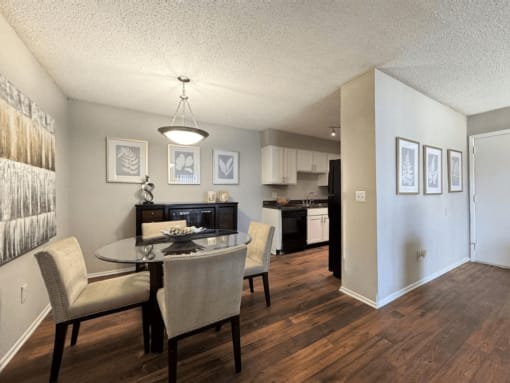 a dining room and kitchen with a table and chairs