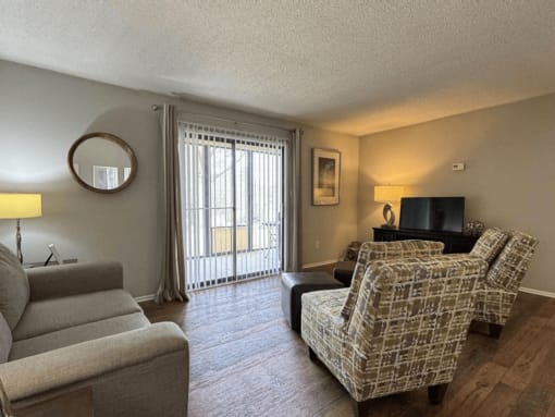 a living room with a couch and a chair and a television