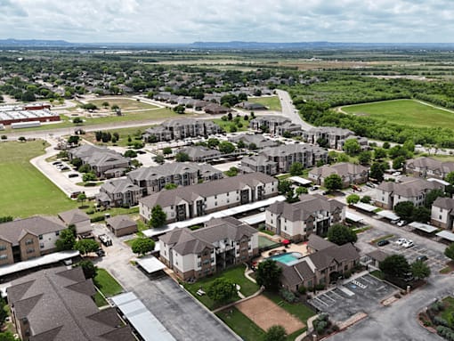 A large residential complex with a swimming pool and a playground.
