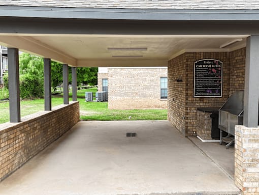 A car wash station with a sign that says Car Wash Rules.