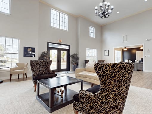 A living room with a patterned chair and a coffee table.