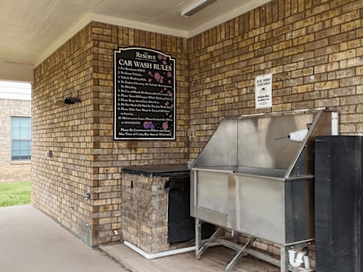 A sign on a brick wall that says