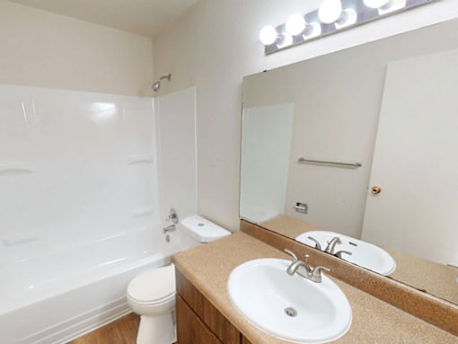 A white toilet sits next to a sink in a bathroom.