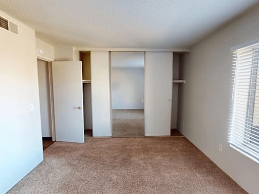 A room with a carpeted floor and white walls.
