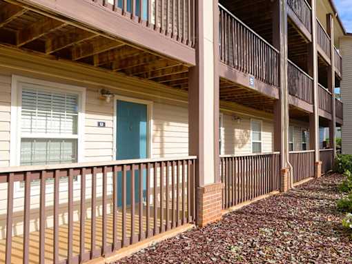 a porch of an apartment building with a blue door