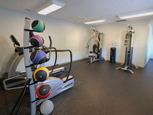 a gym with weights and other exercise equipment in a room