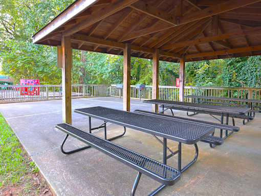 a picnic area with benches and a pavilion