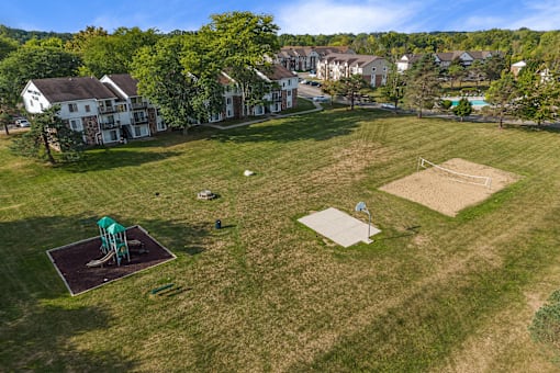 A park with a playground and a soccer field.