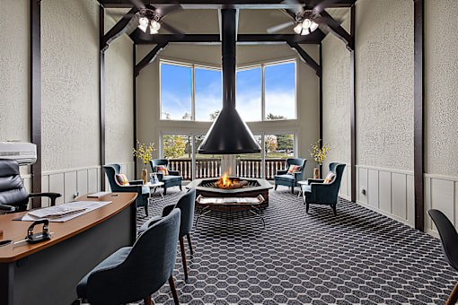 A room with a fireplace and a ceiling fan.