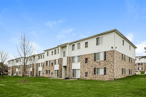 A large building with a lawn in front of it.