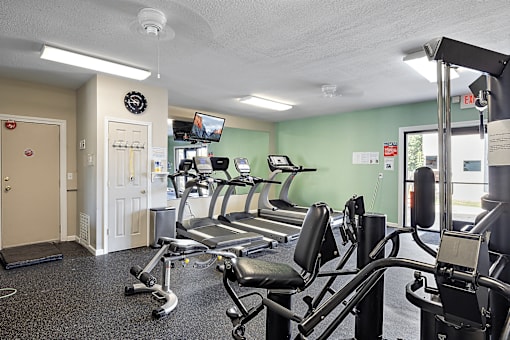 A gym with treadmills and exercise equipment.