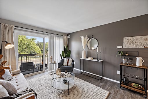 A living room with a couch, chair, and a coffee table.