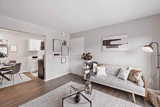 A living room with a white couch and a coffee table.