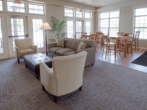 a living room with couches and chairs and a dining room with tables and chairs