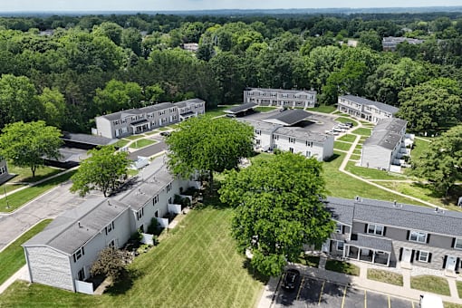 A large building complex surrounded by trees.