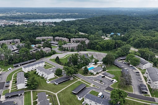 A bird's eye view of a residential area with houses and a swimming pool.