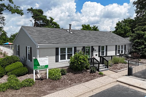 A house with a sign that says Rolling Pines.
