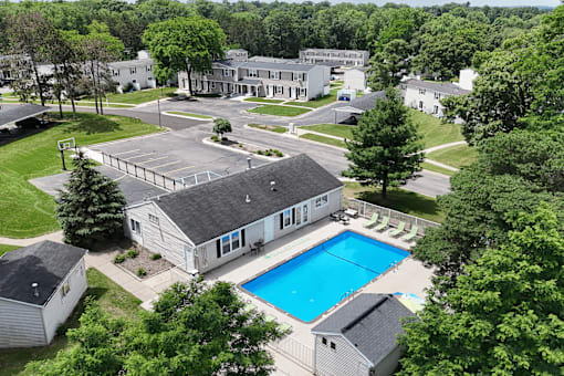 A large building with a pool in front of it.