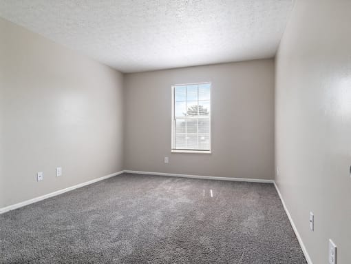 bedroom with carpet and a window