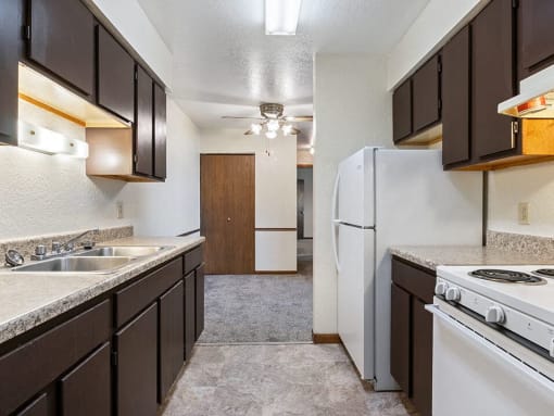a kitchen with a white stove and a refrigerator