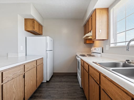 a kitchen with a sink and a refrigerator