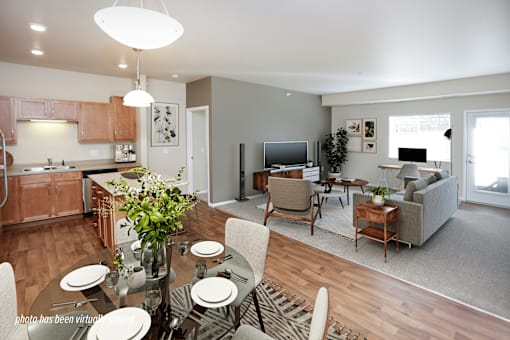 A modern kitchen with a dining table set for four.