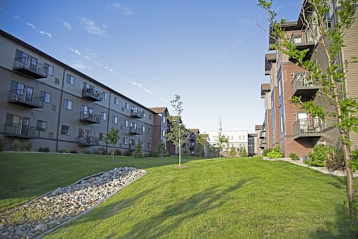A grassy area in front of apartment buildings.