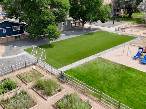 A soccer field with a goal in the middle of it.