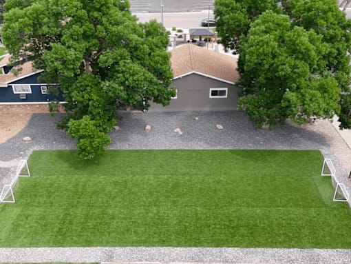 A house with a grey roof and a green lawn.