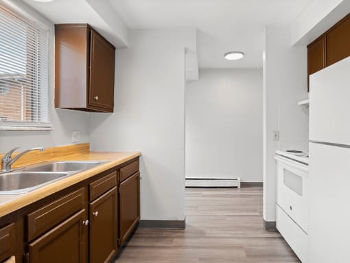 a kitchen with a sink and a stove and a refrigerator