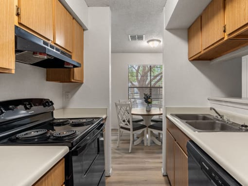 a kitchen with a stove and a sink and a table