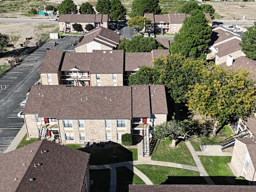 A bird's eye view of a residential area with houses and trees.