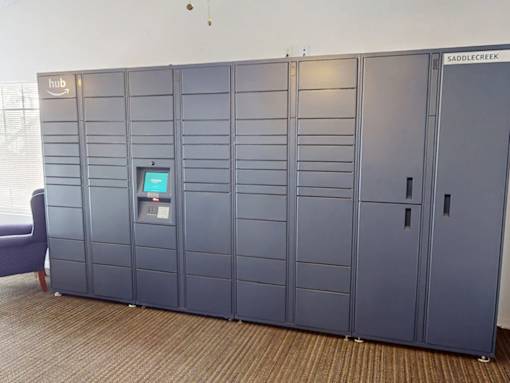 A row of tall, gray lockers are labeled Saddlecreek.