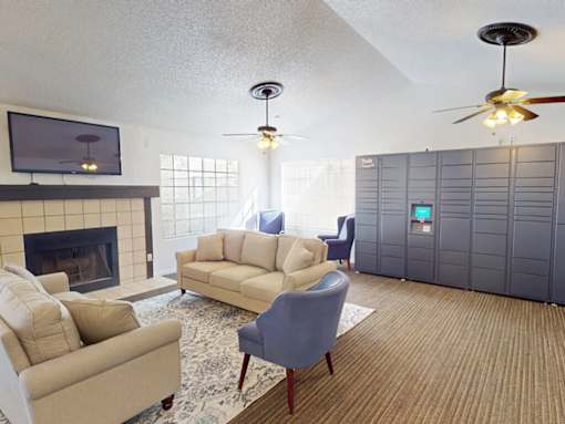 A living room with a fireplace, two couches, and a television.